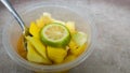 A bowl of healthy fresh fruit salad, made from sliced Ã¢â¬â¹Ã¢â¬â¹pineapple, mango and lime, top view Royalty Free Stock Photo